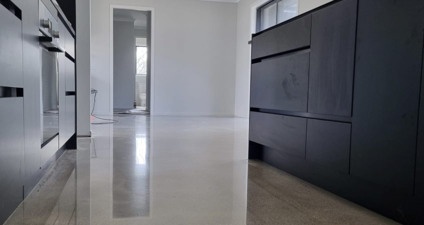 Salt and Pepper beachhouse finish to a kitchen floor with grey black kitchen cabinets on either side