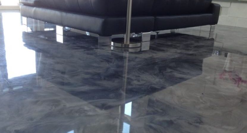 marble effect epoxy floor in lounge area under a sofa in grey swirl tones