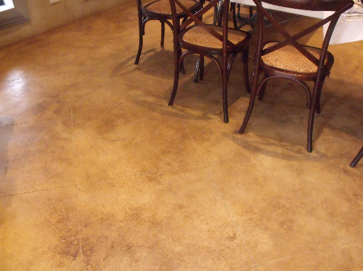 chemical stain for concrete floor nz grinders tauranga kitchen Concrete floor under dining table stained with chemicals brown tones NZ Grinders Tauranga