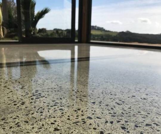 concrete floor with exposed stone