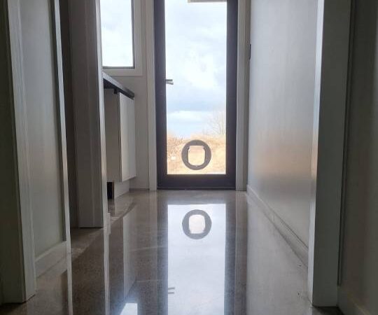 Salt and pepper finish for a beach house polished concrete floor nz grinders tauranga hallway