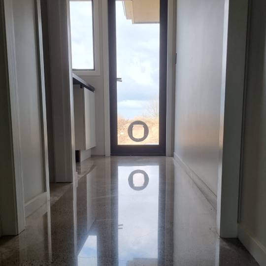 Salt and pepper finish for a beach house polished concrete floor nz grinders tauranga hallway